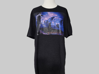 Black t-shirt with graphic design on a gray background
